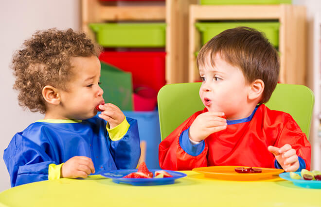 Two small children eating